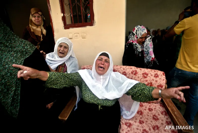 Relatives of Palestinian militant Ismail Odeh mourn during his funeral in Beit Hanun in the northern Gaza Strip on June 18, 2012. Odeh was one of two Palestinians killed in an Israeli strike on north Gaza in the morning,...