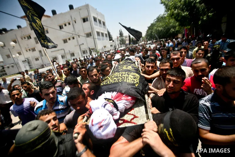 Palestinian mourners carry the body of one of the two Palestinians who were killed in an Israeli air strike on north Gaza during their funeral on June 18, 2012. Witnesses identified the two men as members of the radical...