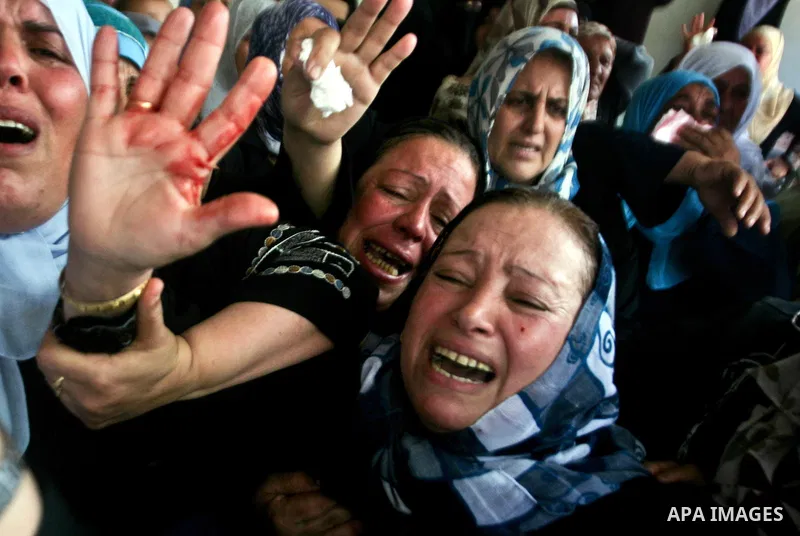 Relatives of Palestinian militant Ismail Odeh mourn during his funeral in Beit Hanun in the northern Gaza Strip on June 18, 2012. Odeh was one of two Palestinians killed in an Israeli strike on north Gaza in the morning,...