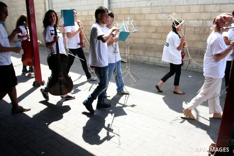 Palestinian, Israeli and foreign musicians band during their presentation at the Israeli military Qalandia checkpoint between Jerusalem city and Ramallah in West Bank on 18 June 2012. Photo by Issam Rimawi