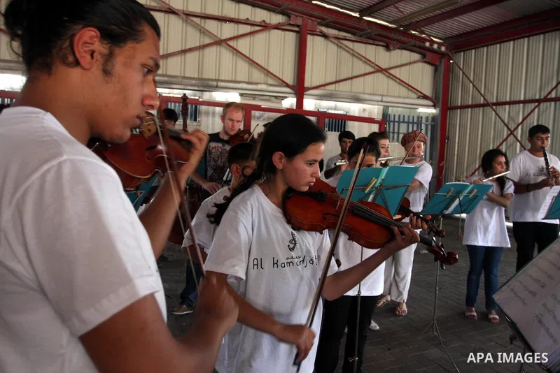Palestinian, Israeli and foreign musicians band during their presentation at the Israeli military Qalandia checkpoint between Jerusalem city and Ramallah in West Bank on 18 June 2012. Photo by Issam Rimawi