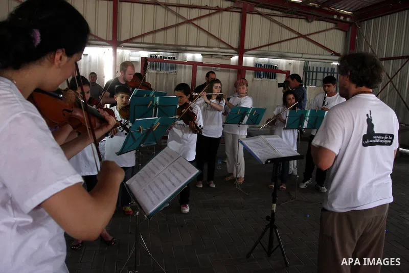 Palestinian, Israeli and foreign musicians band during their presentation at the Israeli military Qalandia checkpoint between Jerusalem city and Ramallah in West Bank on 18 June 2012. Photo by Issam Rimawi