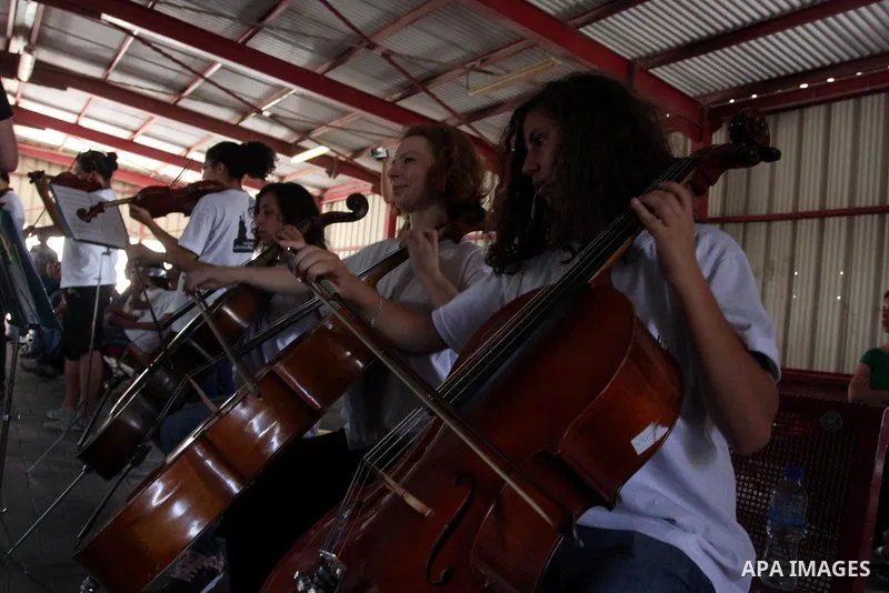 Palestinian, Israeli and foreign musicians band during their presentation at the Israeli military Qalandia checkpoint between Jerusalem city and Ramallah in West Bank on 18 June 2012. Photo by Issam Rimawi