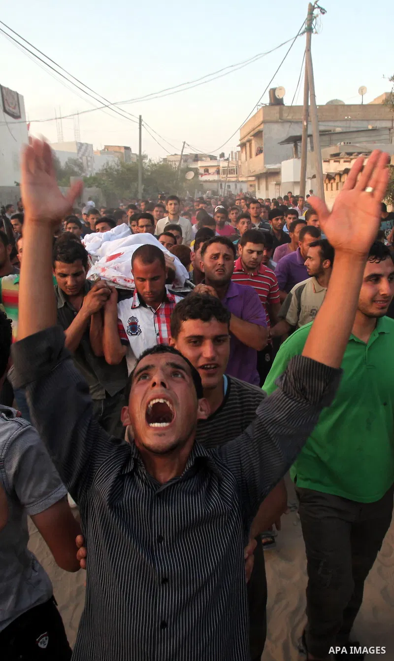 Palestinians carry the body of Abd El-Kareem Al-Za'aneen during his funeral after he was killed in an Israeli air strike near Beit Hanoun, northern Gaza Strip, Monday, June 18, 2012. The Israeli strike comes after killed...