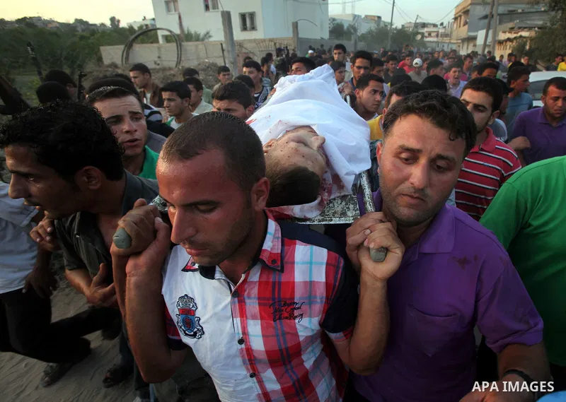 Palestinians carry the body of Abd El-Kareem Al-Za'aneen during his funeral after he was killed in an Israeli air strike near Beit Hanoun, northern Gaza Strip, Monday, June 18, 2012. The Israeli strike comes after killed...