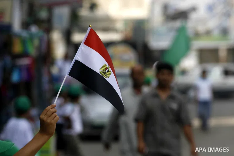 Palestinian boys supporter hold up Egyptian flags as they celebrate in Rafah, in the southern Gaza Strip, 19 June 2012. Egypt's Muslim Brotherhood claimed on 18 June 2012 victory in Egypt's first presidential election si...