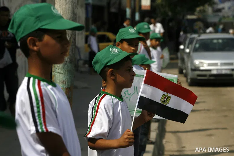 Palestinian boys supporter hold up Egyptian flags as they celebrate in Rafah, in the southern Gaza Strip, 19 June 2012. Egypt's Muslim Brotherhood claimed on 18 June 2012 victory in Egypt's first presidential election si...