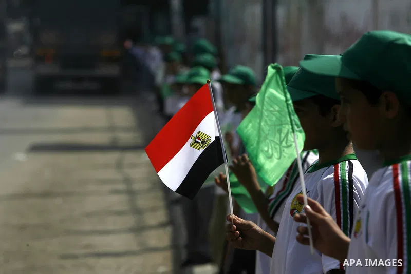 Palestinian boys supporter hold up Egyptian flags as they celebrate in Rafah, in the southern Gaza Strip, 19 June 2012. Egypt's Muslim Brotherhood claimed on 18 June 2012 victory in Egypt's first presidential election si...