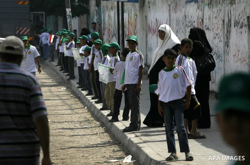 Palestinian boys supporter hold up Egyptian flags as they celebrate in Rafah, in the southern Gaza Strip, 19 June 2012. Egypt's Muslim Brotherhood claimed on 18 June 2012 victory in Egypt's first presidential election si...