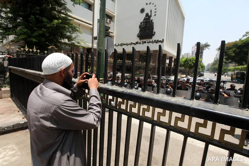 An Egyptian man stands in front of riot police blocking the access to the street of the parliament in Cairo, Egypt, 09 June 2012. A new constitutional document issued by the Supreme Council of the Armed Forces (SCAF), gr...