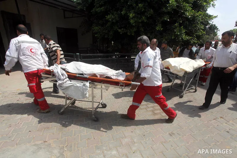 Palestinian medics transmit body of Palestinian Mohammed Abu Maleg to the hospital in Dir al-Balah in the central Gaza Strip June 19, 2012. An Israeli air strike killed two Palestinians, one of them abu Maleg, in the Gaz...