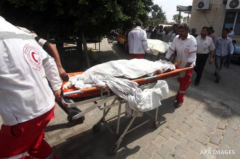 Palestinian medics transmit body of Palestinian Mohammed Abu Maleg to the hospital in Dir al-Balah in the central Gaza Strip June 19, 2012. An Israeli air strike killed two Palestinians, one of them abu Maleg, in the Gaz...