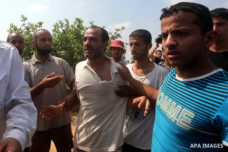 A relative of Palestinian Mohammed abu Maleg reacts after his body was recovered in Dir al-Balah in the central Gaza Strip June 19, 2012. An Israeli air strike killed two Palestinians, one of them abu Maleg, in the Gaza...