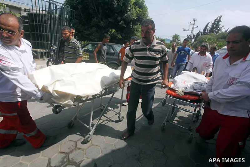 Palestinian medics transmit body of Palestinian Mohammed Abu Maleg to the hospital in Dir al-Balah in the central Gaza Strip June 19, 2012. An Israeli air strike killed two Palestinians, one of them abu Maleg, in the Gaz...