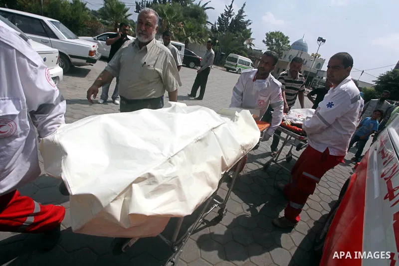 Palestinian medics transmit body of Palestinian Mohammed Abu Maleg to the hospital in Dir al-Balah in the central Gaza Strip June 19, 2012. An Israeli air strike killed two Palestinians, one of them abu Maleg, in the Gaz...
