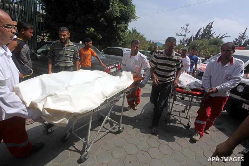 Palestinian medics transmit body of Palestinian Mohammed Abu Maleg to the hospital in Dir al-Balah in the central Gaza Strip June 19, 2012. An Israeli air strike killed two Palestinians, one of them abu Maleg, in the Gaz...