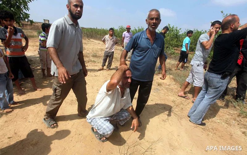 A relative of Palestinian Mohammed abu Maleg reacts after his body was recovered in Dir al-Balah in the central Gaza Strip June 19, 2012. An Israeli air strike killed two Palestinians, one of them abu Maleg, in the Gaza...