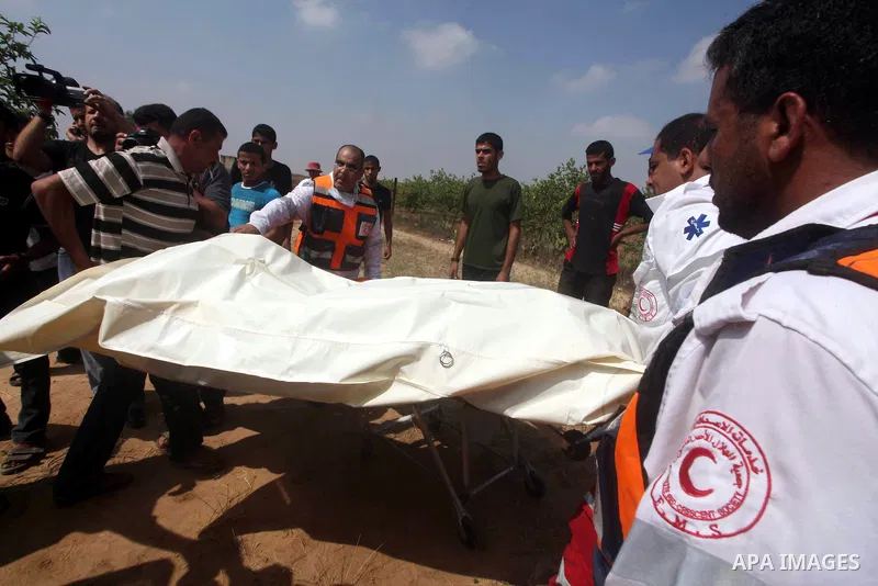 Palestinian medics recover Mohammed Abu Maleg body in Dir al-Balah in the central Gaza Strip June 19, 2012. An Israeli air strike killed two Palestinians, one of them abu Maleg, in the Gaza Strip on Tuesday near the bord...