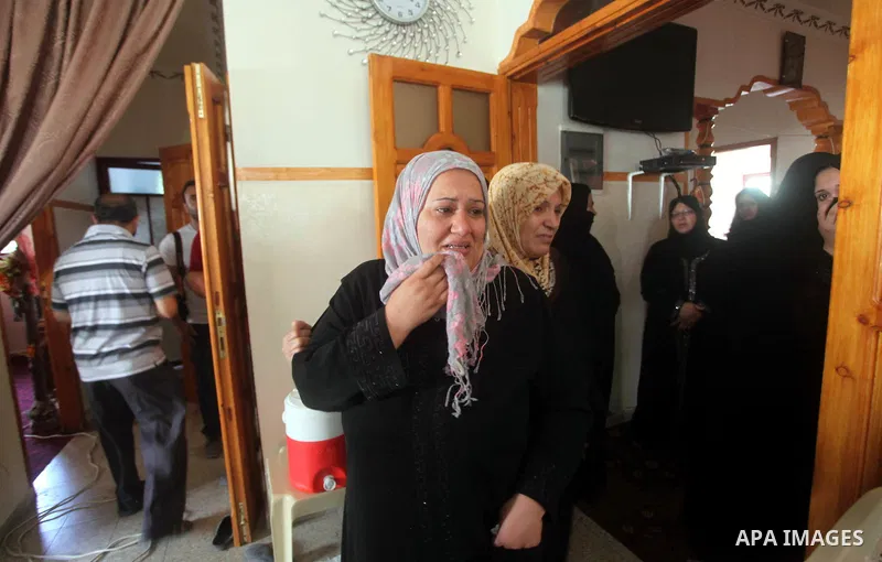 Relatives of Palestinian Mohammed abu Maleg mourn during his funeral in Al-Maghazi refugee camp in the central Gaza Strip June 19, 2012. An Israeli air strike killed two Palestinians, one of them abu Maleg, in the Gaza S...