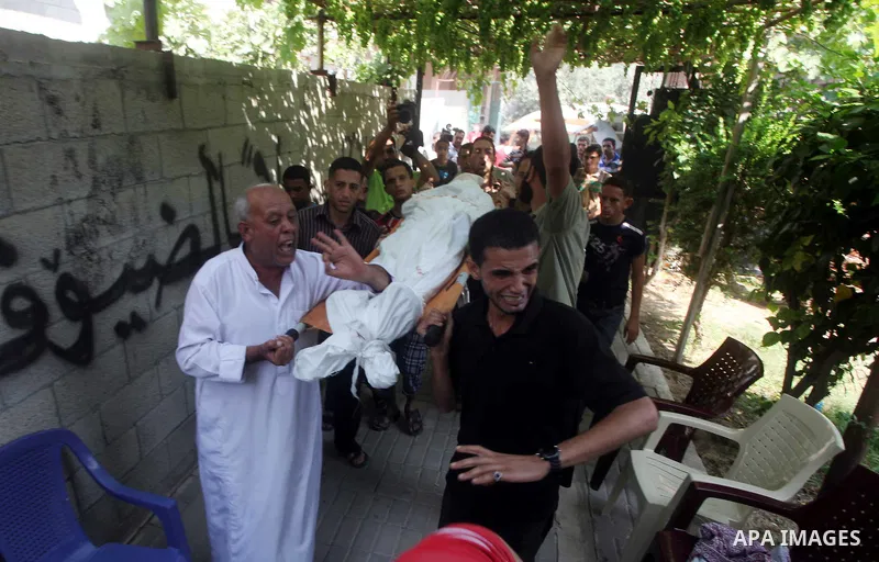 Relatives of Palestinian Mohammed abu Maleg mourn during his funeral in Al-Maghazi refugee camp in the central Gaza Strip June 19, 2012. An Israeli air strike killed two Palestinians, one of them abu Maleg, in the Gaza S...