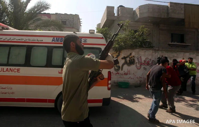 A relative of Palestinian Mohammed abu Maleg, shots fire during his funeral in Al-Maghazi refugee camp in the central Gaza Strip June 19, 2012. An Israeli air strike killed two Palestinians, one of them abu Maleg, in the...