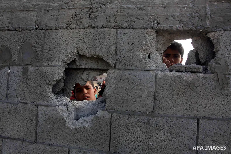 Palestinians inspect the place that was under an Israeli air strike in Dir al-Balah in the central Gaza Strip June 19, 2012. An Israeli army statement said the Israeli air force targeted Palestinian militants in the cent...