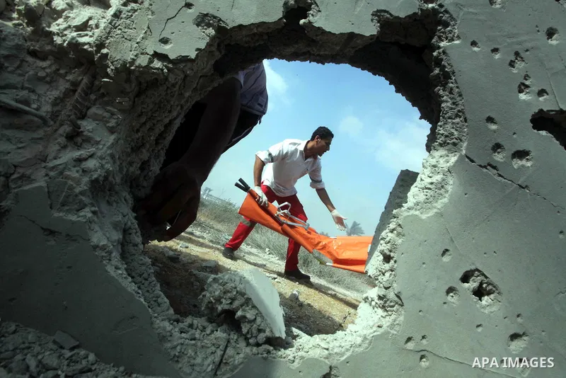 Palestinian medics inspect the place that was under an Israeli air strike in Dir al-Balah in the central Gaza Strip June 19, 2012. An Israeli army statement said the Israeli air force targeted Palestinian militants in th...