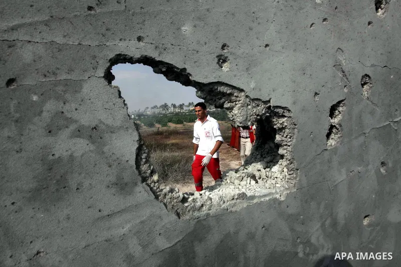 Palestinian medics inspect the place that was under an Israeli air strike in Dir al-Balah in the central Gaza Strip June 19, 2012. An Israeli army statement said the Israeli air force targeted Palestinian militants in th...