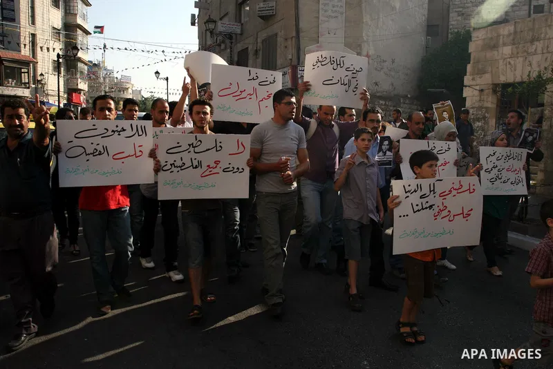 Palestinian demonstrators take part in a protest against the Lebanese army assault on Palestinian refugees in Nahr al-Bared refugee camp, killing some of them, in the West Bank city of Ramallah, on 19 June 2012. Photo by...
