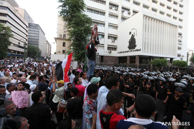 Egyptians protestors chat anti-Supreme Council for the Armed Forces as they stand guard during a protest against the military council outside Egypt's parliament in Cairo June 19, 2012. Egypt's Muslim Brotherhood declared...