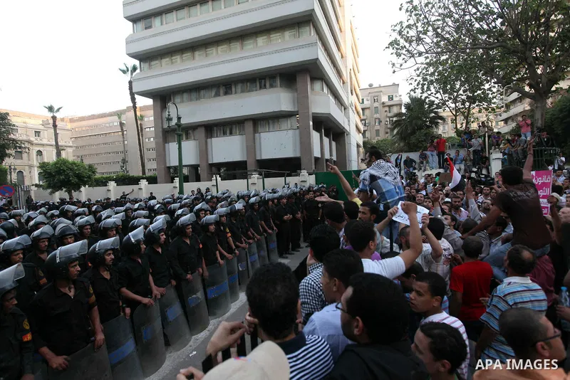 Egyptians protestors chat anti-Supreme Council for the Armed Forces as they stand guard during a protest against the military council outside Egypt's parliament in Cairo June 19, 2012. Egypt's Muslim Brotherhood declared...