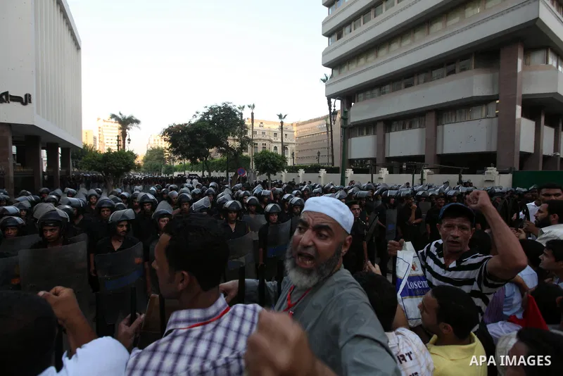 Egyptians protestors chat anti-Supreme Council for the Armed Forces as they stand guard during a protest against the military council outside Egypt's parliament in Cairo June 19, 2012. Egypt's Muslim Brotherhood declared...