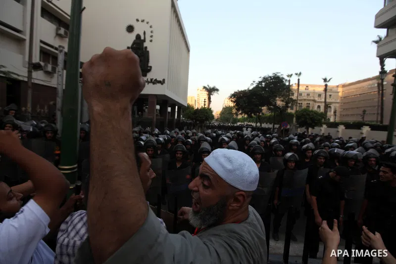 Egyptians protestors chat anti-Supreme Council for the Armed Forces as they stand guard during a protest against the military council outside Egypt's parliament in Cairo June 19, 2012. Egypt's Muslim Brotherhood declared...
