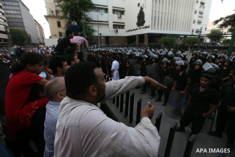 Egyptians protestors chat anti-Supreme Council for the Armed Forces as they stand guard during a protest against the military council outside Egypt's parliament in Cairo June 19, 2012. Egypt's Muslim Brotherhood declared...