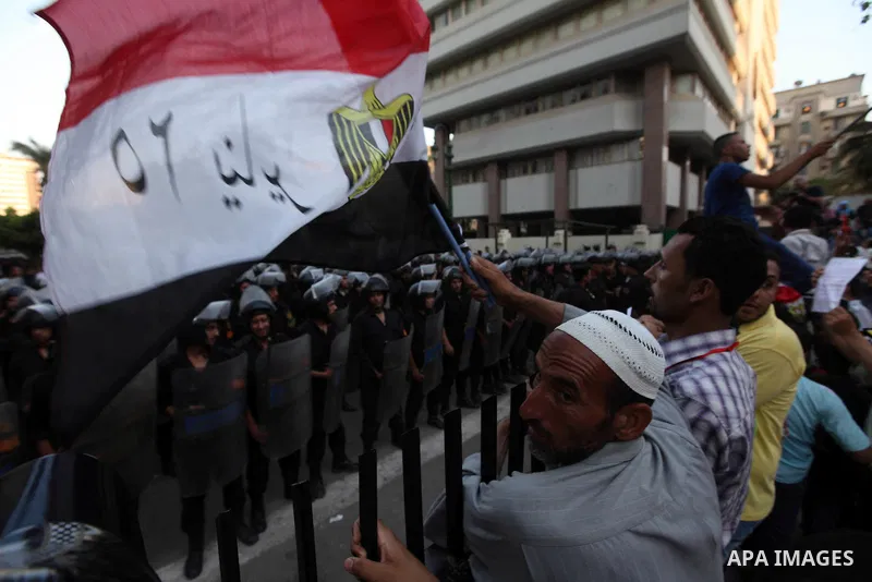 Egyptians protestors chat anti-Supreme Council for the Armed Forces as they stand guard during a protest against the military council outside Egypt's parliament in Cairo June 19, 2012. Egypt's Muslim Brotherhood declared...