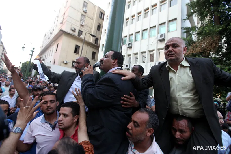Egyptians protestors chat anti-Supreme Council for the Armed Forces as they stand guard during a protest against the military council outside Egypt's parliament in Cairo June 19, 2012. Egypt's Muslim Brotherhood declared...