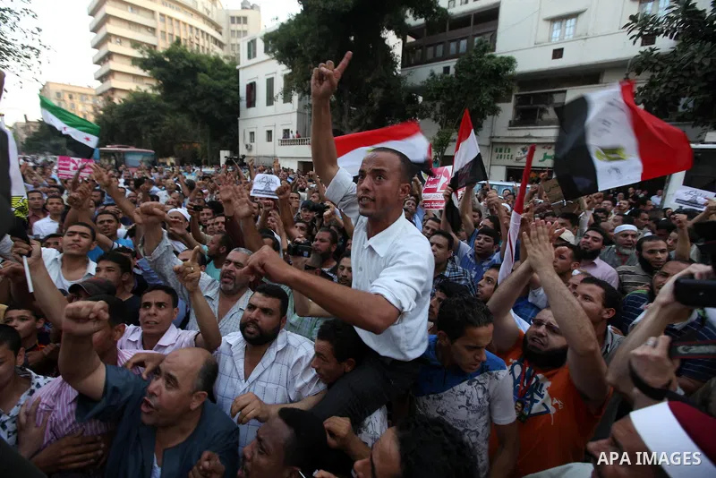 Egyptians protestors chat anti-Supreme Council for the Armed Forces as they stand guard during a protest against the military council outside Egypt's parliament in Cairo June 19, 2012. Egypt's Muslim Brotherhood declared...