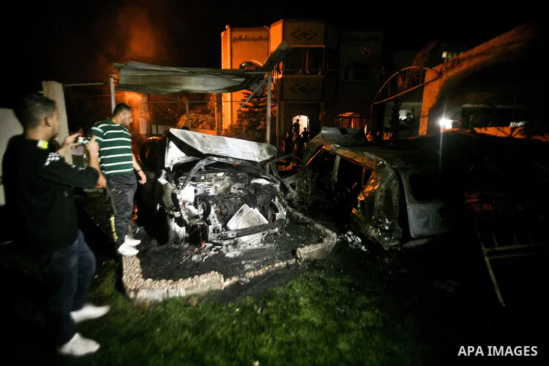 A Palestinian inspects a destroyed car after it was hit in an Israeli air strike in Al Zaiton area in the east of Gaza city on, 20 June 2012. Photo by Ali Jadallah