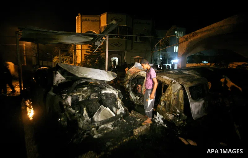 A Palestinian inspects a destroyed car after it was hit in an Israeli air strike in Al Zaiton area in the east of Gaza city on, 20 June 2012. Photo by Ali Jadallah