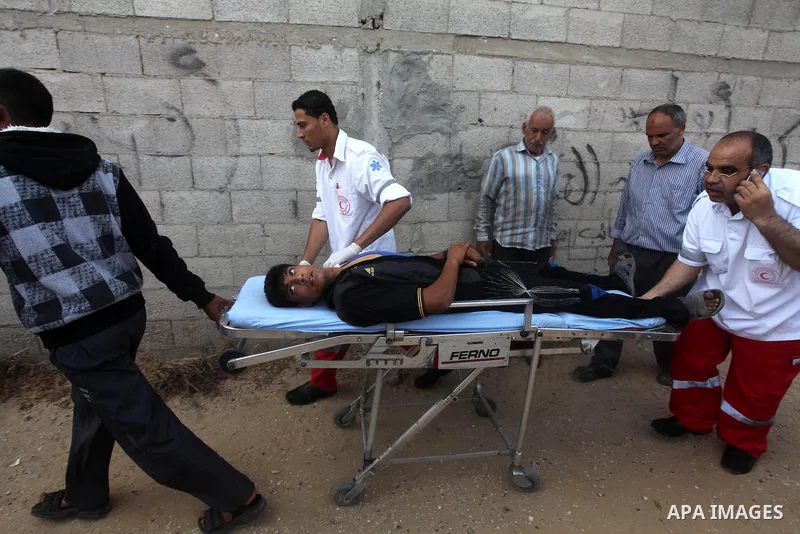 Palestinian medics transmit palestinian man to the hospital in Dir al-Balah in the central Gaza Strip June 20, 2012. The Israeli military said it had struck militant sites on Wednesday in retaliation to rocket fire into...