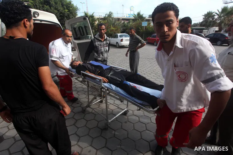 Palestinian medics transmit palestinian man to the hospital in Dir al-Balah in the central Gaza Strip June 20, 2012. The Israeli military said it had struck militant sites on Wednesday in retaliation to rocket fire into...