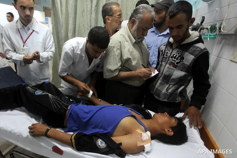 Palestinian medics transmit palestinian man to the hospital in Dir al-Balah in the central Gaza Strip June 20, 2012. The Israeli military said it had struck militant sites on Wednesday in retaliation to rocket fire into...