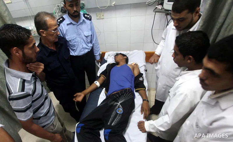 Palestinian medics transmit palestinian man to the hospital in Dir al-Balah in the central Gaza Strip June 20, 2012. The Israeli military said it had struck militant sites on Wednesday in retaliation to rocket fire into...