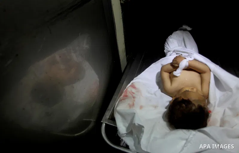 A Palestinian looks at the body of two-year-old girl, Hadeel al-Hadad, at the morgue in the al-Shifa hospital in Gaza City on June 20, 2012. There was no let-up in rocket fire from Gaza with at least 10 hitting the Jewis...