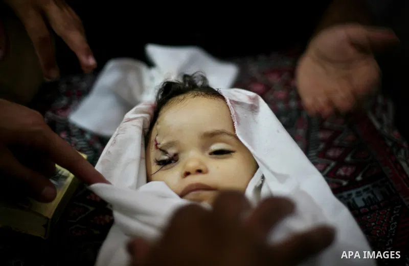 Palestinian mourners pray over the body of Hadeel al-Hadad during her funeral in Gaza City on 20 June 2012. Hadeel was killed June 19 when Palestinian militants launched a rocket from Gaza City, which failed to reach its...