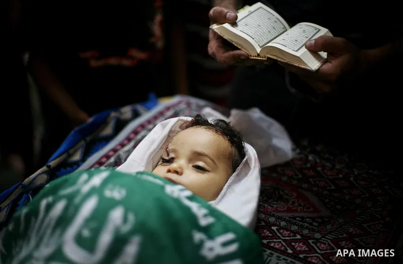 Palestinian mourners pray over the body of Hadeel al-Hadad during her funeral in Gaza City on 20 June 2012. Hadeel was killed June 19 when Palestinian militants launched a rocket from Gaza City, which failed to reach its...