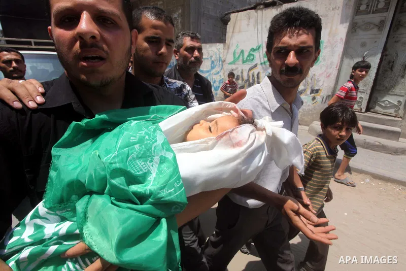 A Palestinian relative carries the body of two-year-old Hadeel al Hadad, during her funeral in Gaza City, Wednesday, June 20, 2012. Gaza health official Adham Abu Salmia said an explosion in a house killed al-Hadad and i...