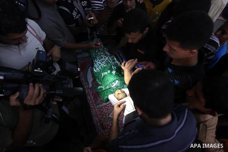 Palestinian mourners pray over the body of Hadeel al-Hadad during her funeral in Gaza City on 20 June 2012. Hadeel was killed June 19 when Palestinian militants launched a rocket from Gaza City, which failed to reach its...