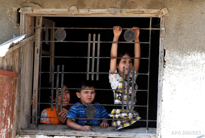 Palestinian children watch the funeral of Hadeel al-Hadad in Gaza City June 20, 2012. The two-year-old Gazan girl died and her brother was wounded when militants launched a rocket close by, Palestinian witnesses said. An...
