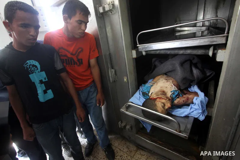 Relatives of ten-year-old Palestinian Mohammed Zohde Al-Dam mourn over his body in Gaza City 20 June 2012. Mohammed was killed and his father Zohde Al-Dam in an Israeli air strike raising to eight the number of Palestini...